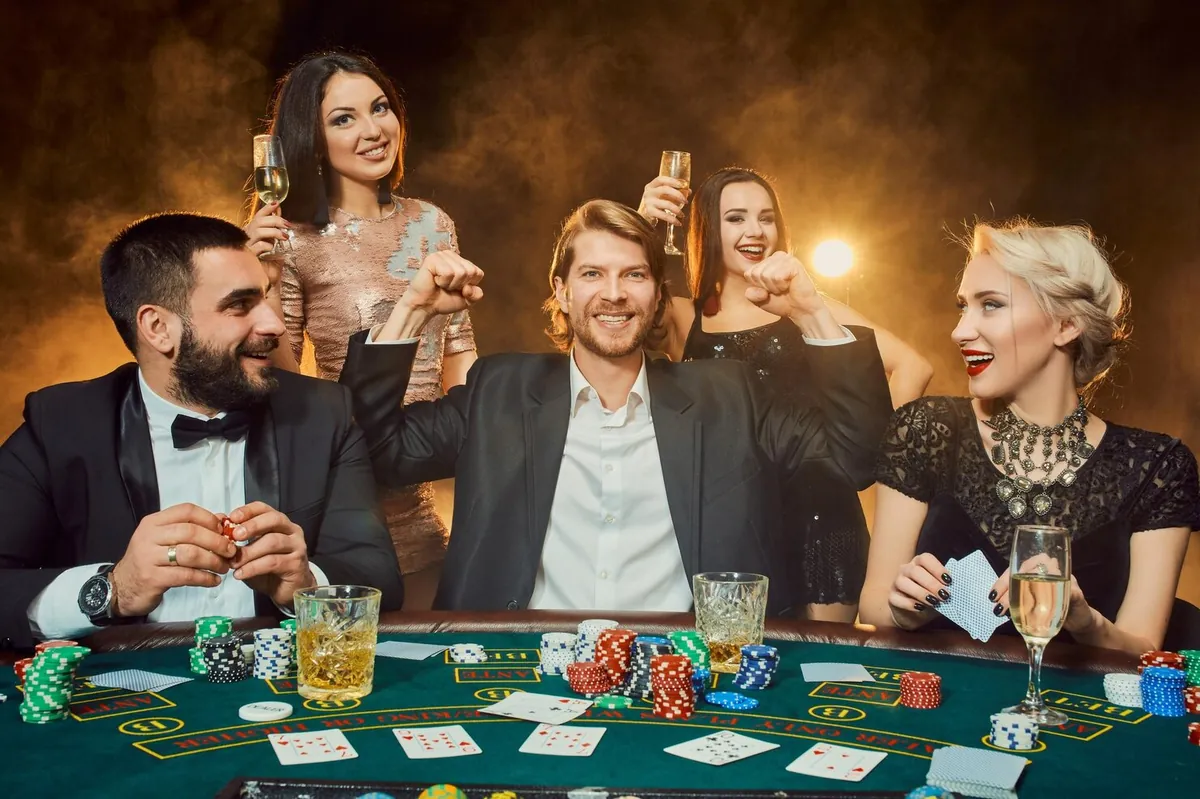 Players betting around an Andar Bahar card table with chips